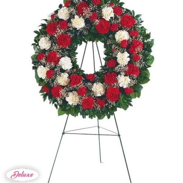 Red and white carnation wreath on a standing easel