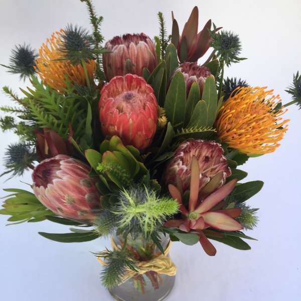 Bouquet of protea flowers in a glass vase