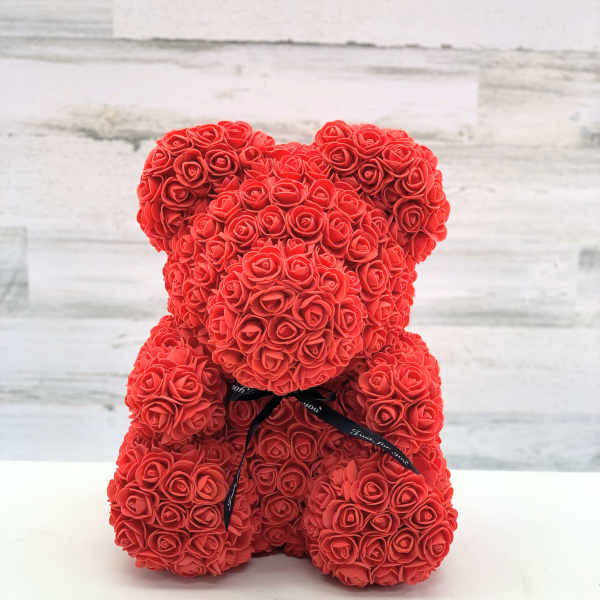 Red rose teddy bear with a black ribbon bow