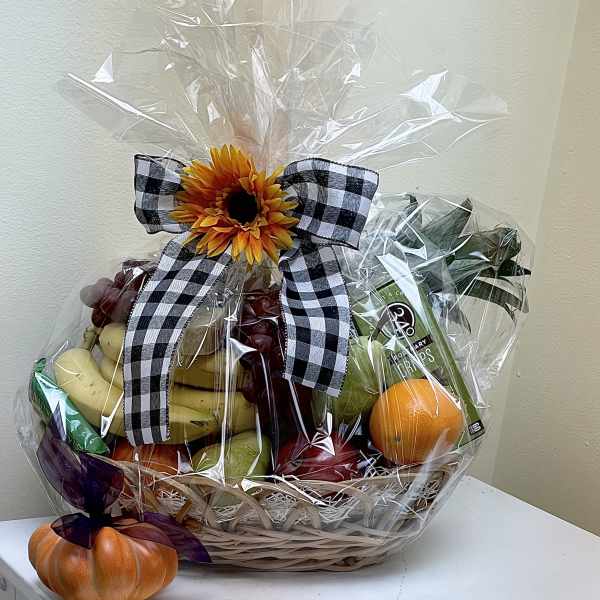 Fruit basket with a sunflower bow and a small pumpkin decoration