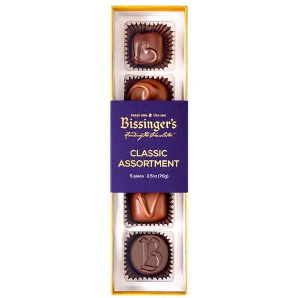 Box of assorted chocolates in purple and gold packaging