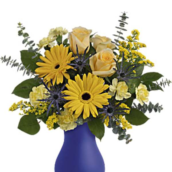 Yellow daisies and roses arranged in a blue vase