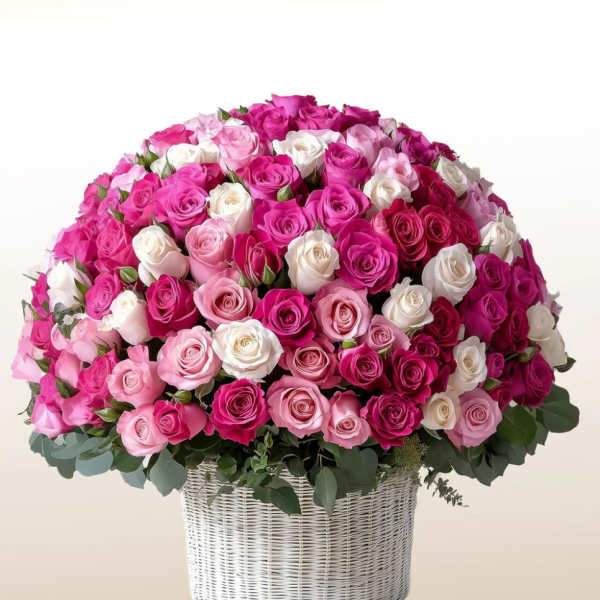 Large basket arrangement of pink, white, and magenta roses