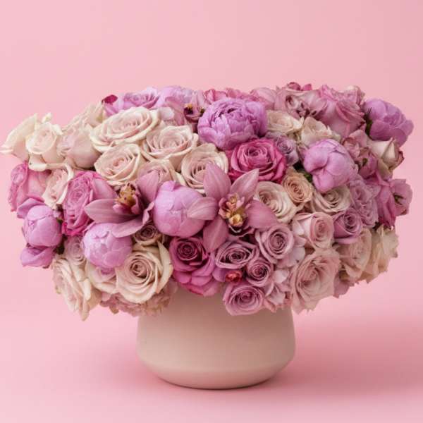Pink and lavender bouquet of roses and peonies in a white vase