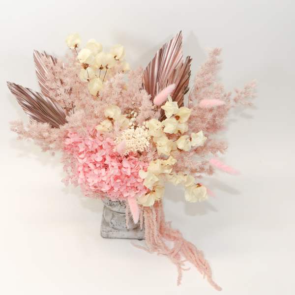 Pink and cream dried floral arrangement in a gray vase