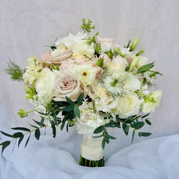 White and blush bouquet of roses and lisianthus with greenery