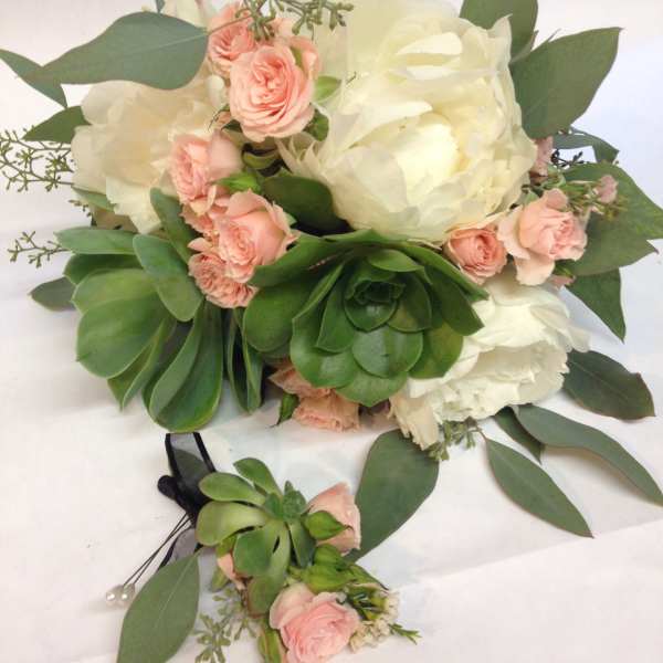 Bouquet of white peonies and pink spray roses with succulents