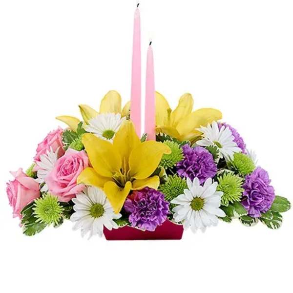 Pink and yellow floral centerpiece with two pink candles