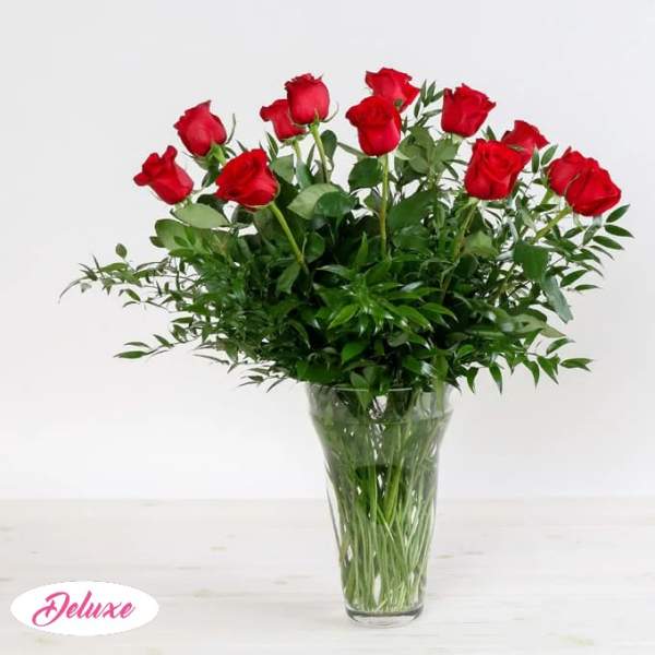 Red roses arranged in a clear glass vase