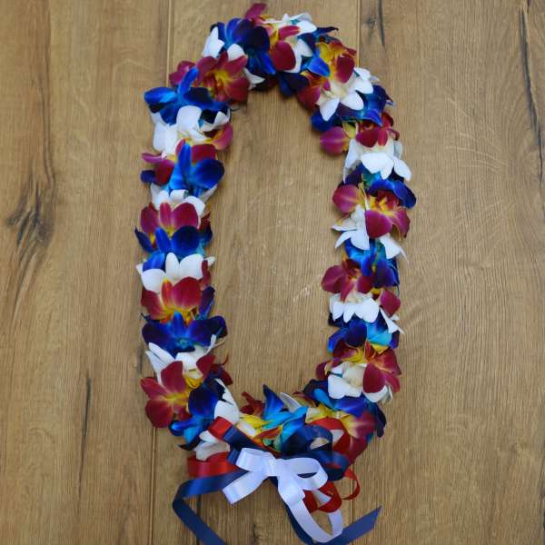A colorful flower lei with blue, white, and pink blossoms and ribbon ties.