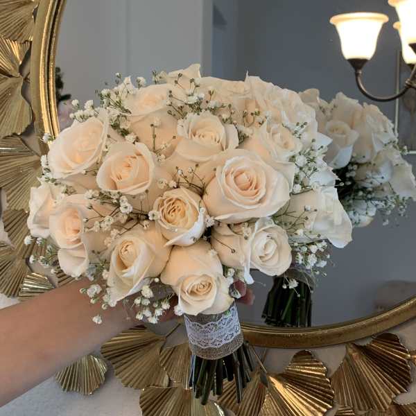 Cream rose bouquet with baby's breath and lace-wrapped stems