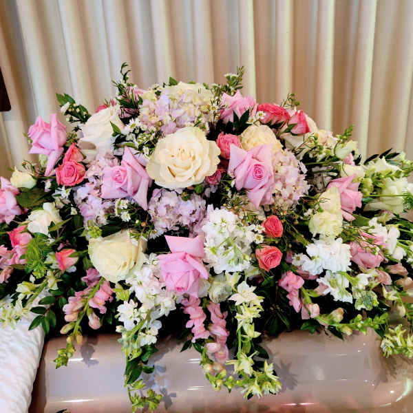 Large pink and white floral arrangement with roses and mixed blooms