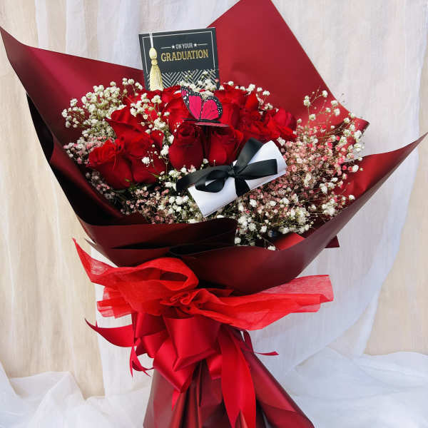 Red rose bouquet with baby's breath and a graduation card
