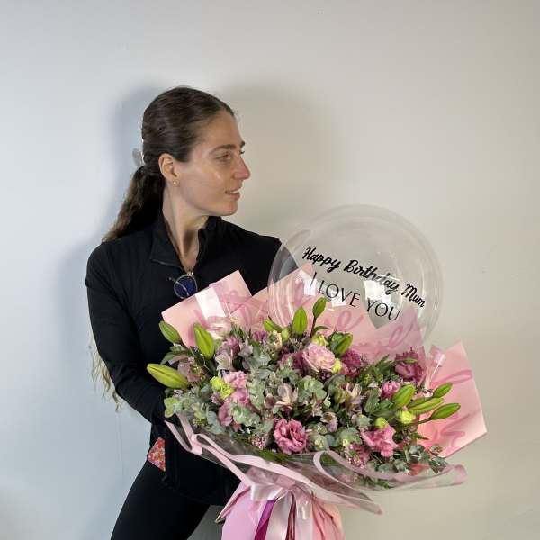 Large pink bouquet with a clear birthday balloon