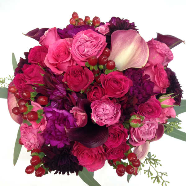 Pink and purple bouquet with roses, calla lilies, and berries