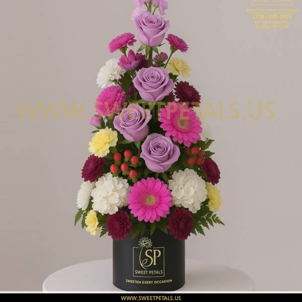 Tiered bouquet of lavender roses, pink gerberas, and mixed daisies in a black box