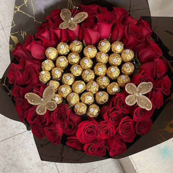 Bouquet of red roses with gold-wrapped chocolates and butterfly decorations