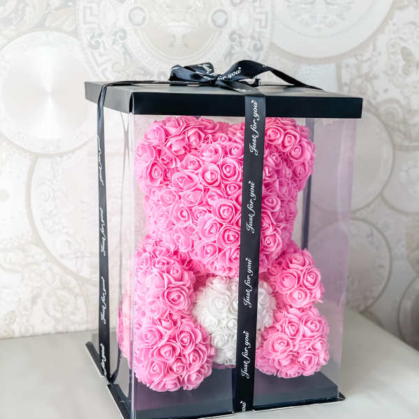 Pink rose teddy bear in a clear gift box with a black ribbon