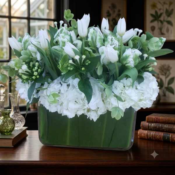 White tulips and hydrangeas arranged in a rectangular vase