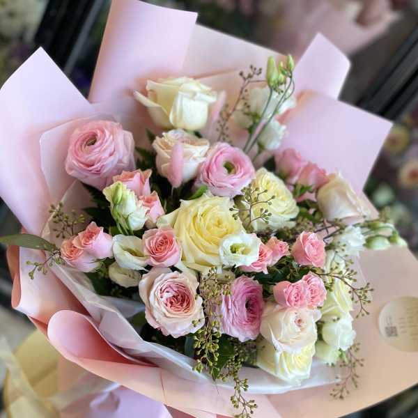 Pink and cream rose bouquet wrapped in pastel paper