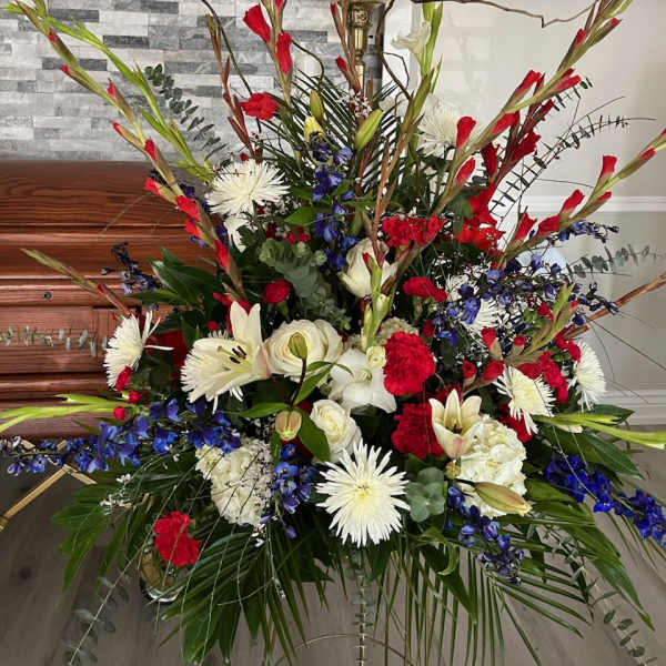 Large red, white, and blue floral arrangement in a room
