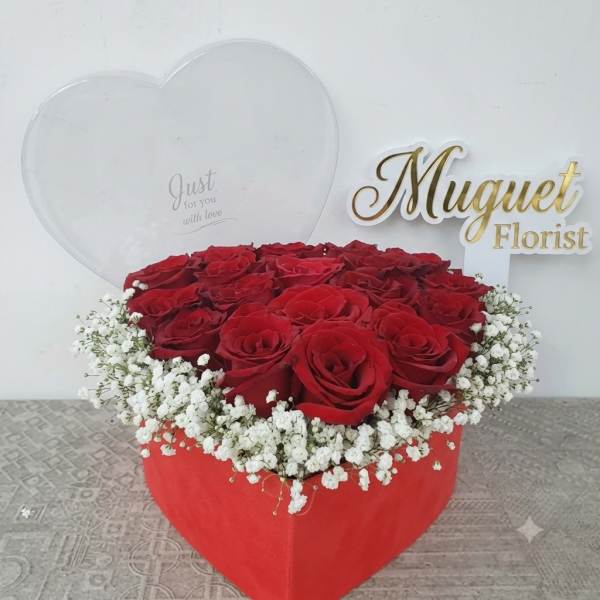 Heart-shaped box of red roses with white baby's breath