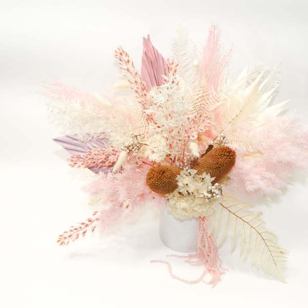 Pastel dried floral arrangement in a white vase