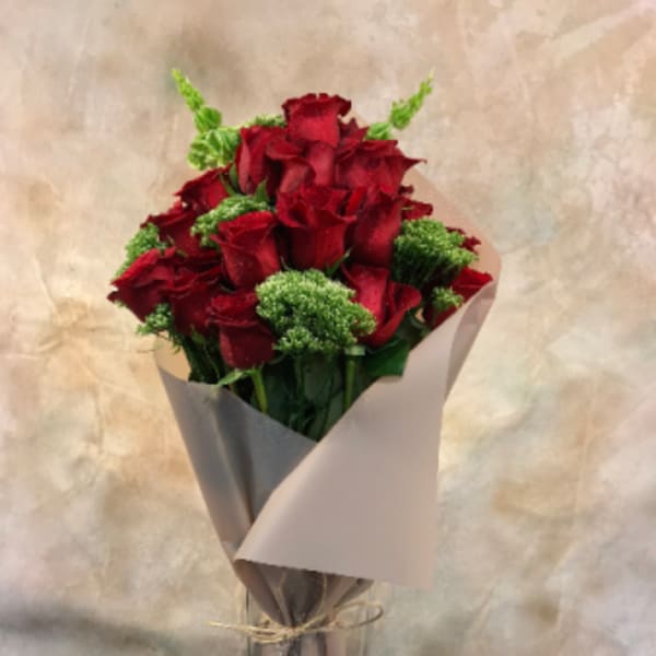 Bouquet of red roses wrapped in gray paper