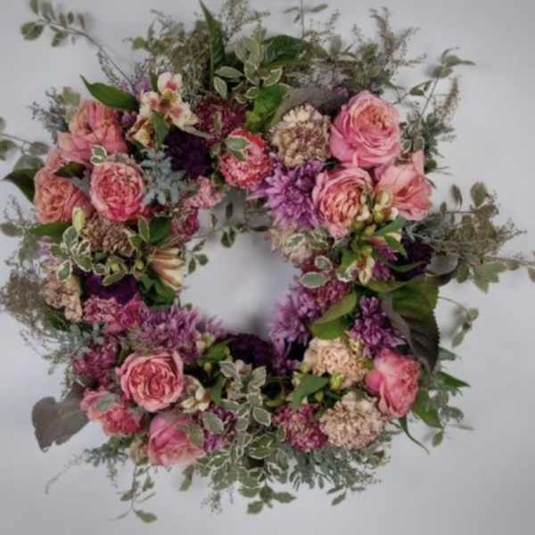 Pink and purple floral wreath with roses and mixed blooms