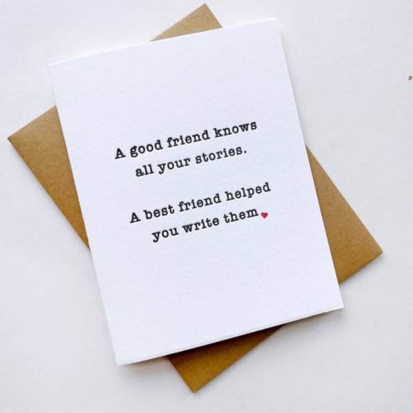 A white greeting card with a friendship message on a kraft envelope