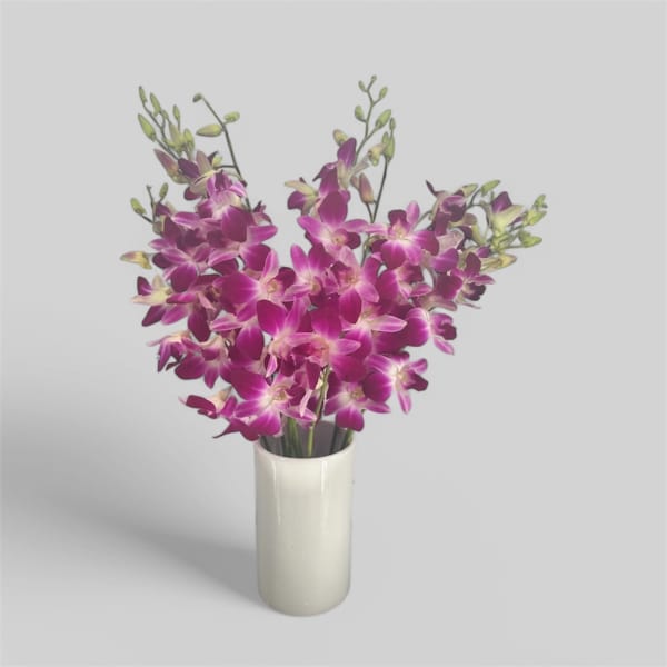 Purple orchid arrangement in a white vase