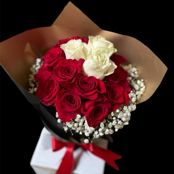 Bouquet of red and white roses with baby's breath in black and tan wrap