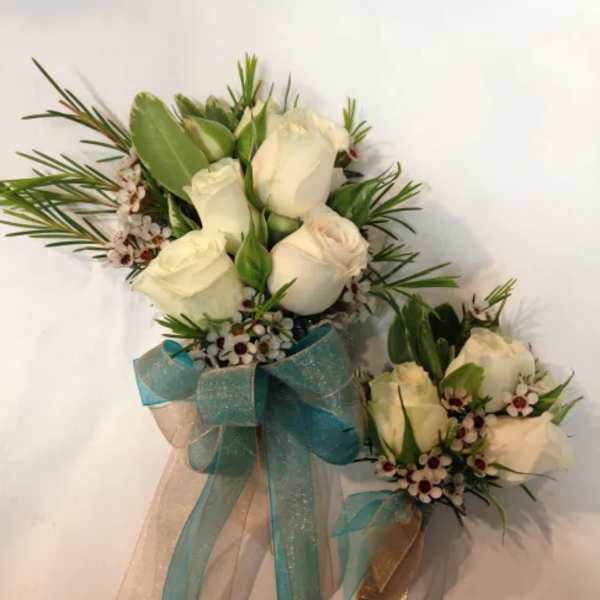 White rose bouquet with blue ribbon and matching boutonniere