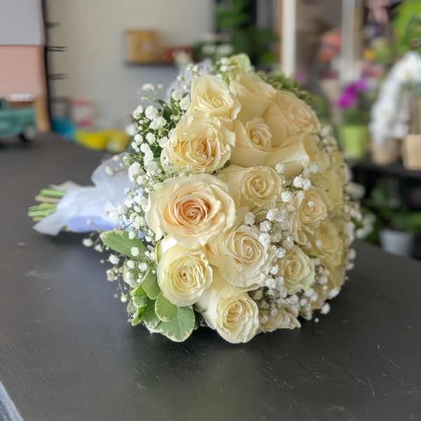 Cream rose bouquet with baby's breath and greenery
