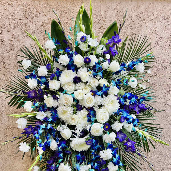 Large blue, white, and purple floral standing spray