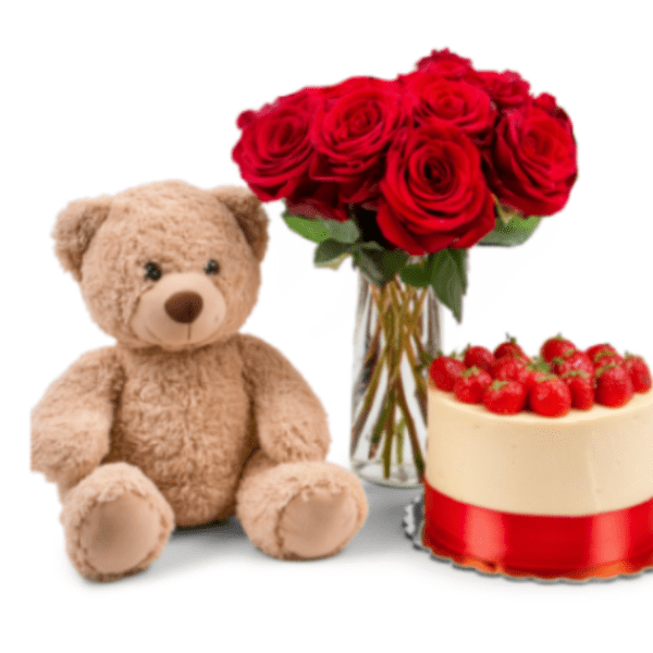 Red roses in a glass vase beside a teddy bear and strawberry cake