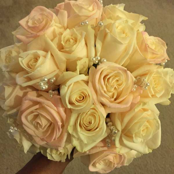Bouquet of pale pink and cream roses with pearl accents