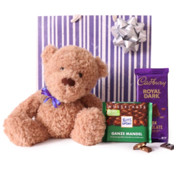 Teddy bear with chocolate bars and a gift bow