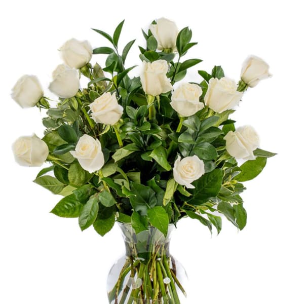 White roses arranged in a clear glass vase
