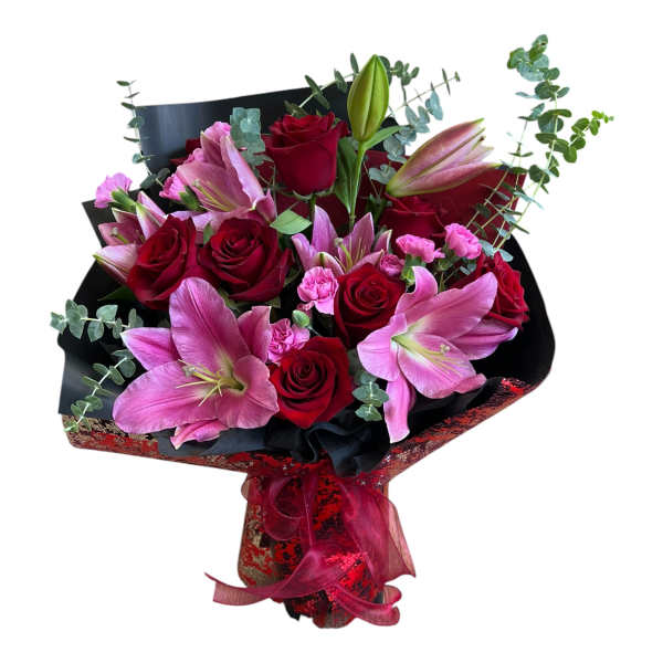 Bouquet of red roses and pink lilies wrapped in black paper