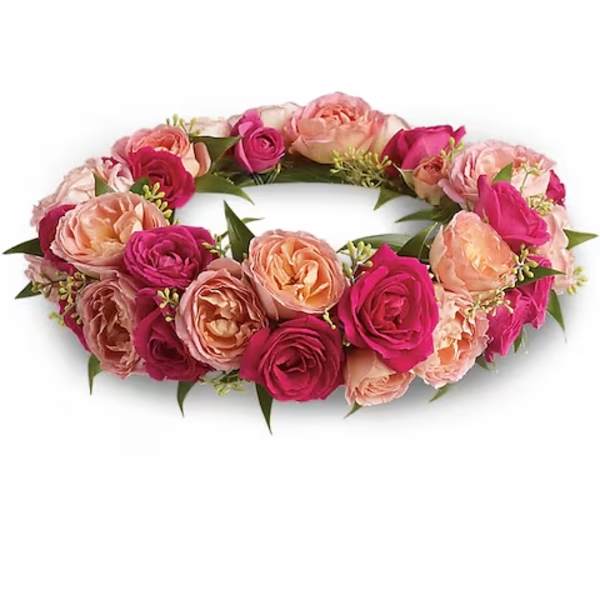 Pink and peach rose floral crown on a white background