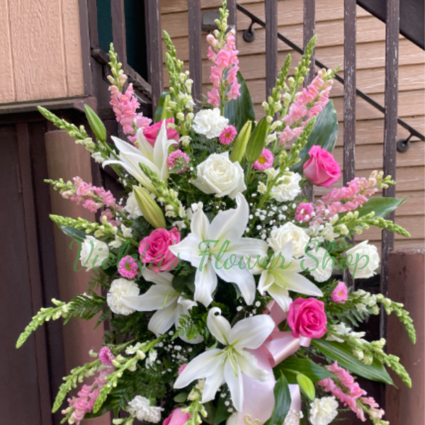 Tall pink and white floral standing spray with lilies and roses