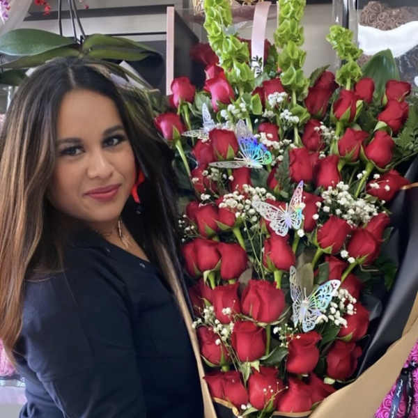 Large bouquet of red roses with green spikes and butterfly picks