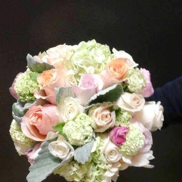Bouquet of pastel roses and hydrangeas with silvery foliage