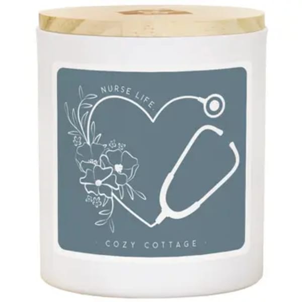 White candle jar with gold lid and nurse-themed label