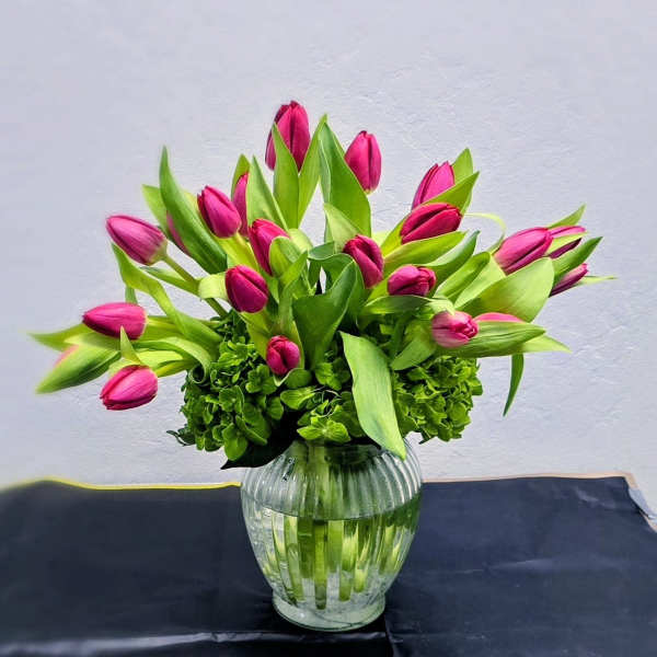 Pink tulips arranged in a clear glass vase