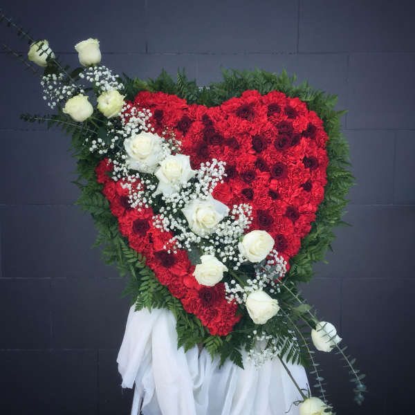 Heart-shaped red floral spray with white roses and greenery