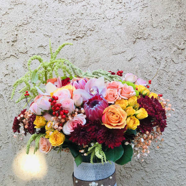 Colorful mixed bouquet in a decorated glass vase