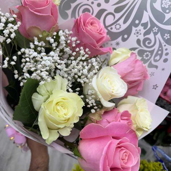 Bouquet of pink and pale yellow roses with baby's breath