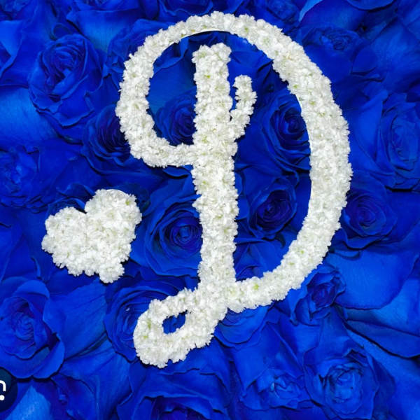 White floral monogram on a blue rose background